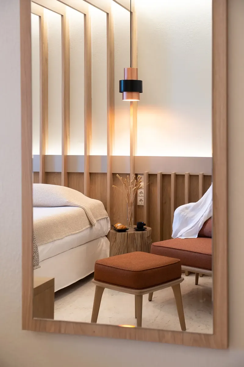 Une chambre supérieure reflétée dans un miroir encadré de bois